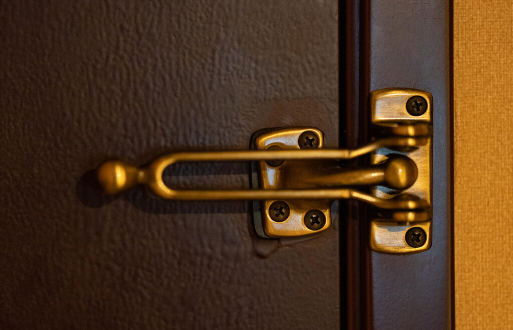 A deadbolt lock on a residential exterior door — the cheapest and most effective home defense investment per dollar