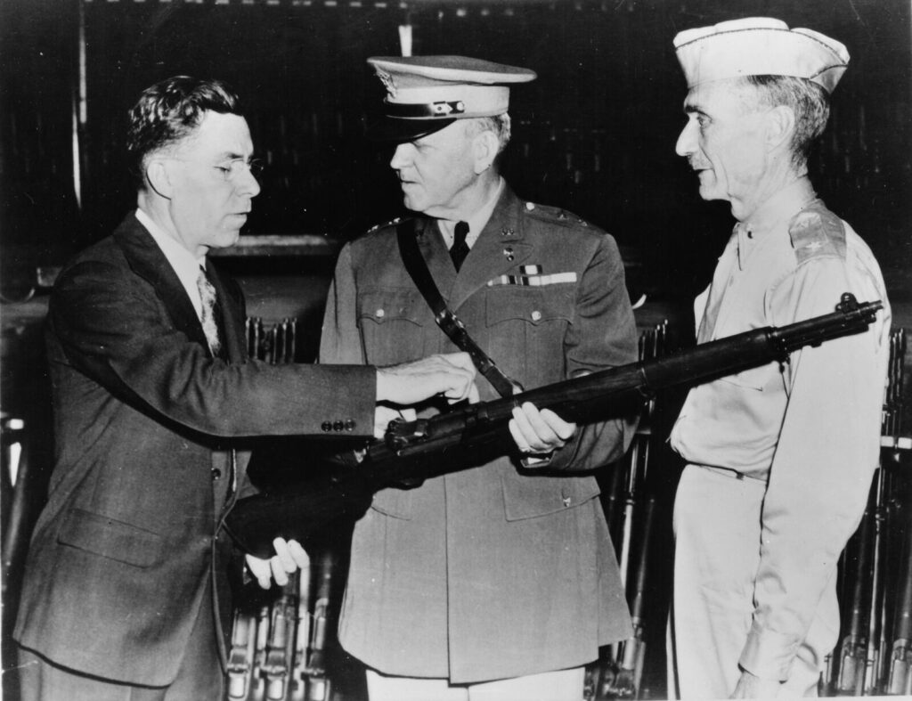 How the Military Buys Its Guns: Procurement, Contracts & Politics (2026) 9 John Cantius Garand, designer of the M1 Garand, at Springfield Armory