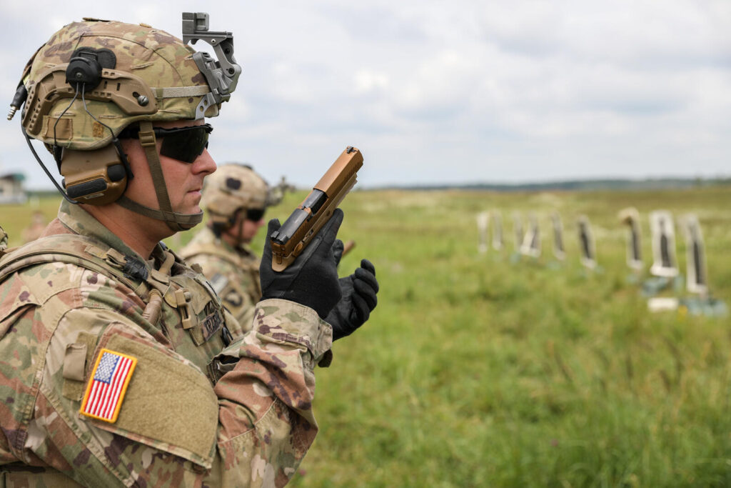 Firearms Training Guide (2026): Courses, Skills & How to Get Better 7 Soldier demonstrating proper pistol grip and stance during marksmanship training — the foundational mechanics every defensive carrier should drill