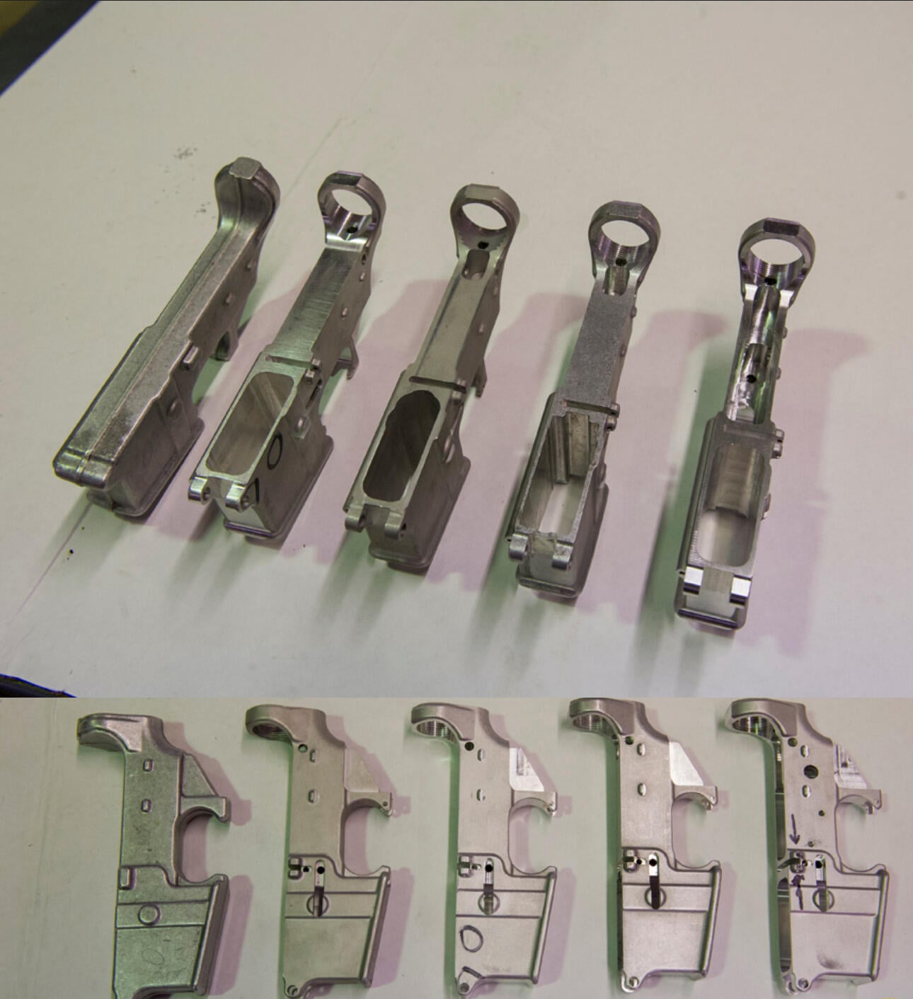 Various stages of AR-15 lower receiver completion from blank forging to 80% to finished serialized receiver — ATF reference photo