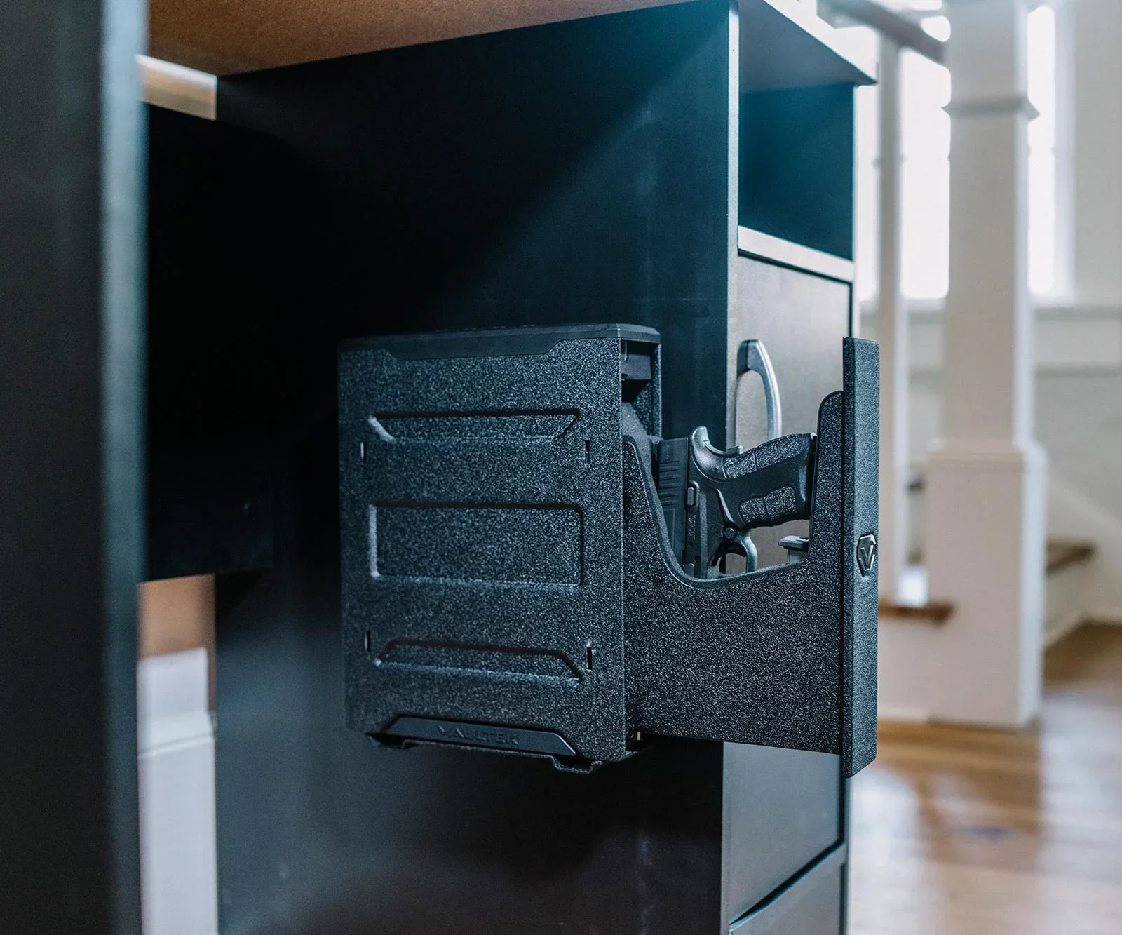 Vaultek Slider Series safe mounted under a cabinet with the tray slid out presenting a pistol grip first
