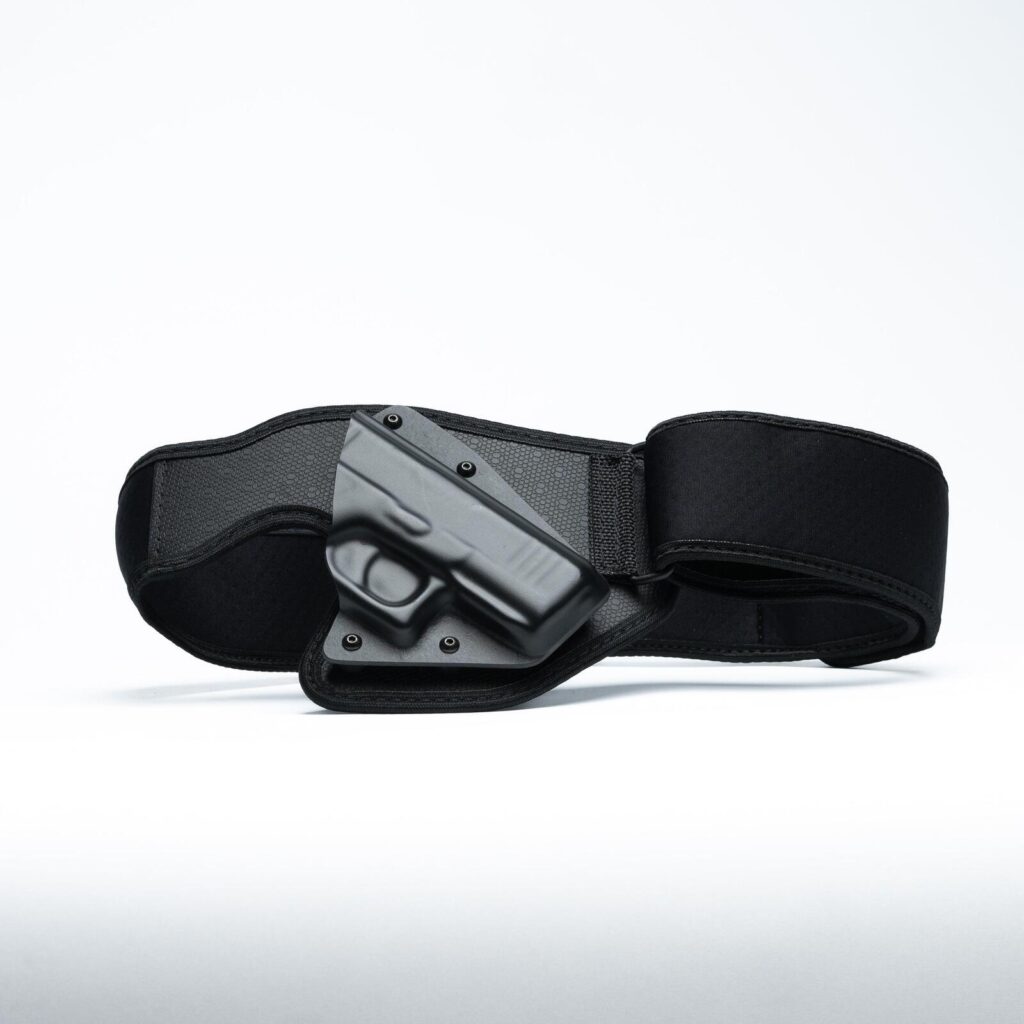 An Alien Gear Low Pro elastic belly band holster with a Kydex shell