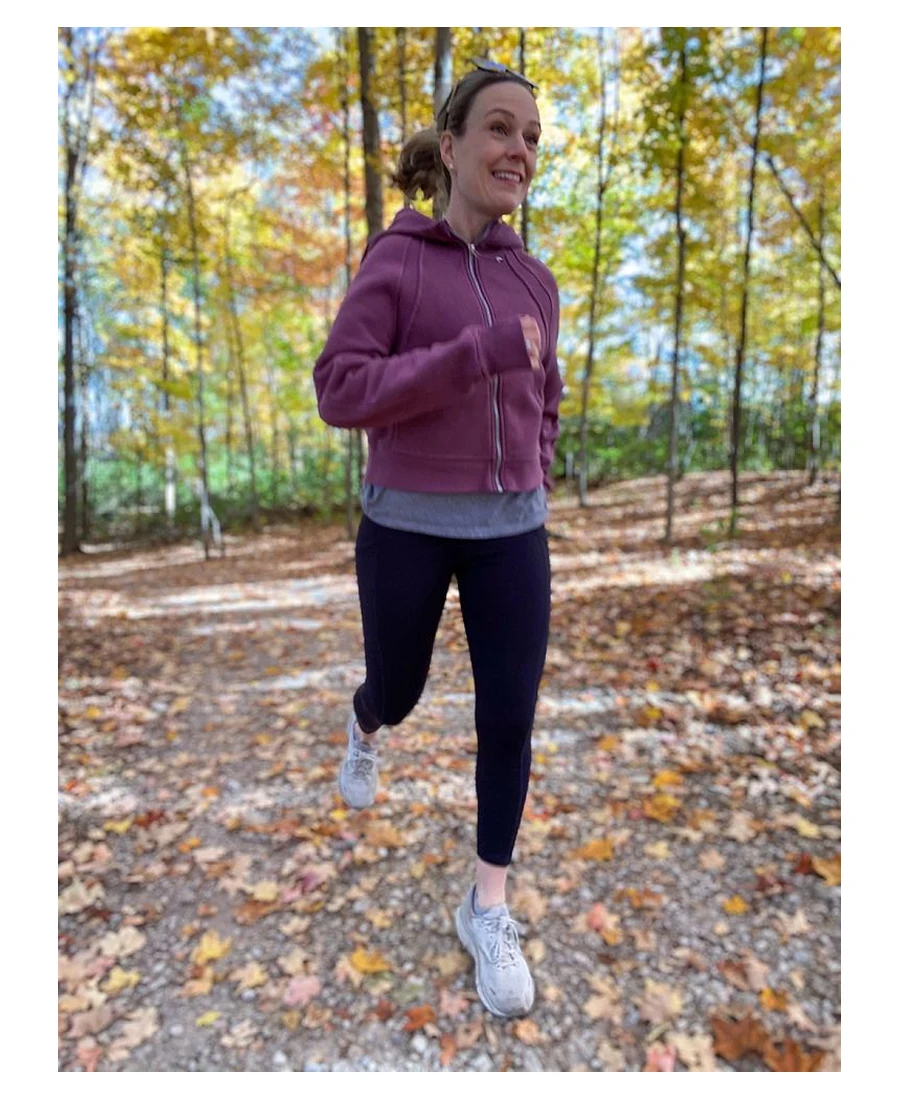 Woman running on a fall trail in Alexo Athletica Matte 7/8 Carrywear concealed carry leggings