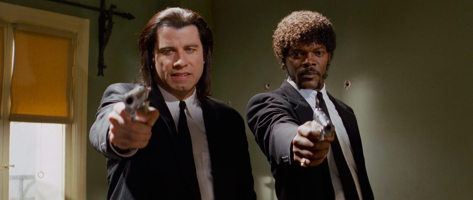 Guns of Pulp Fiction 1994 Vincent Vega and Jules Winnfield pointing pistols apartment scene