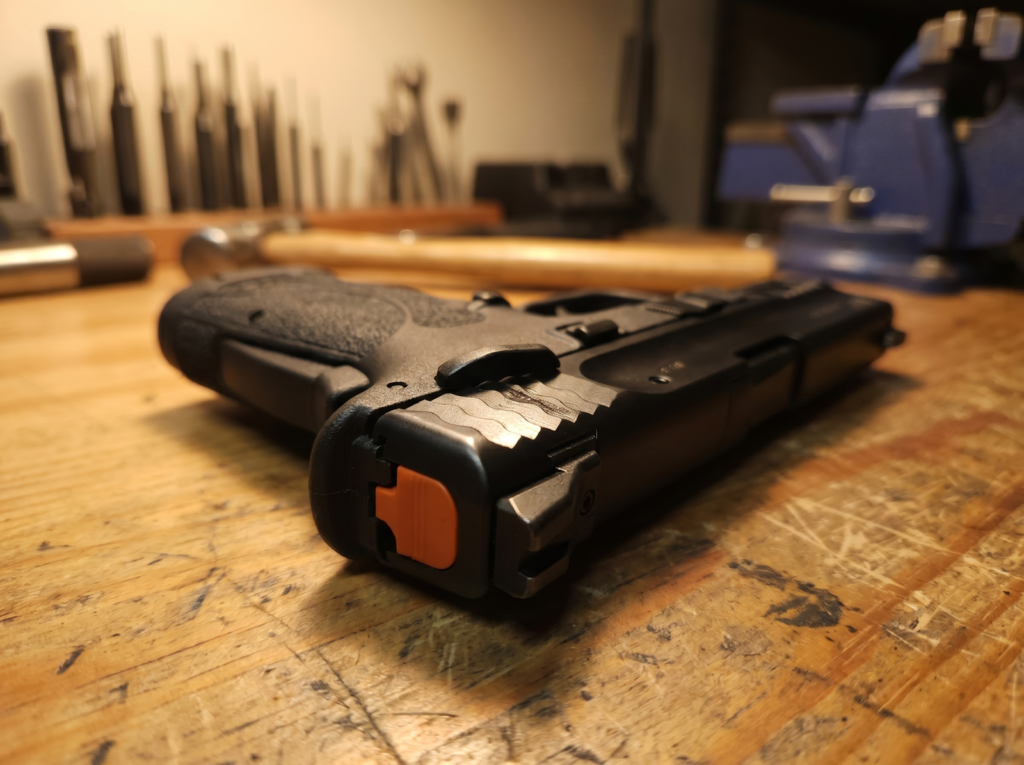 Smith & Wesson EZ Review: Is It Really the Easiest Gun to Shoot? 2 S&W Shield EZ slide showing canted front cocking serrations and load-assist magazine follower