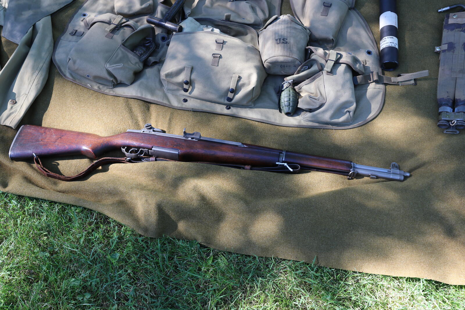 US Gun Statistics (2026): How Many Guns in America, Ownership Data, and Industry Facts 1 M1 Garand rifle laid out with a complete WWII US GI kit on a wool blanket