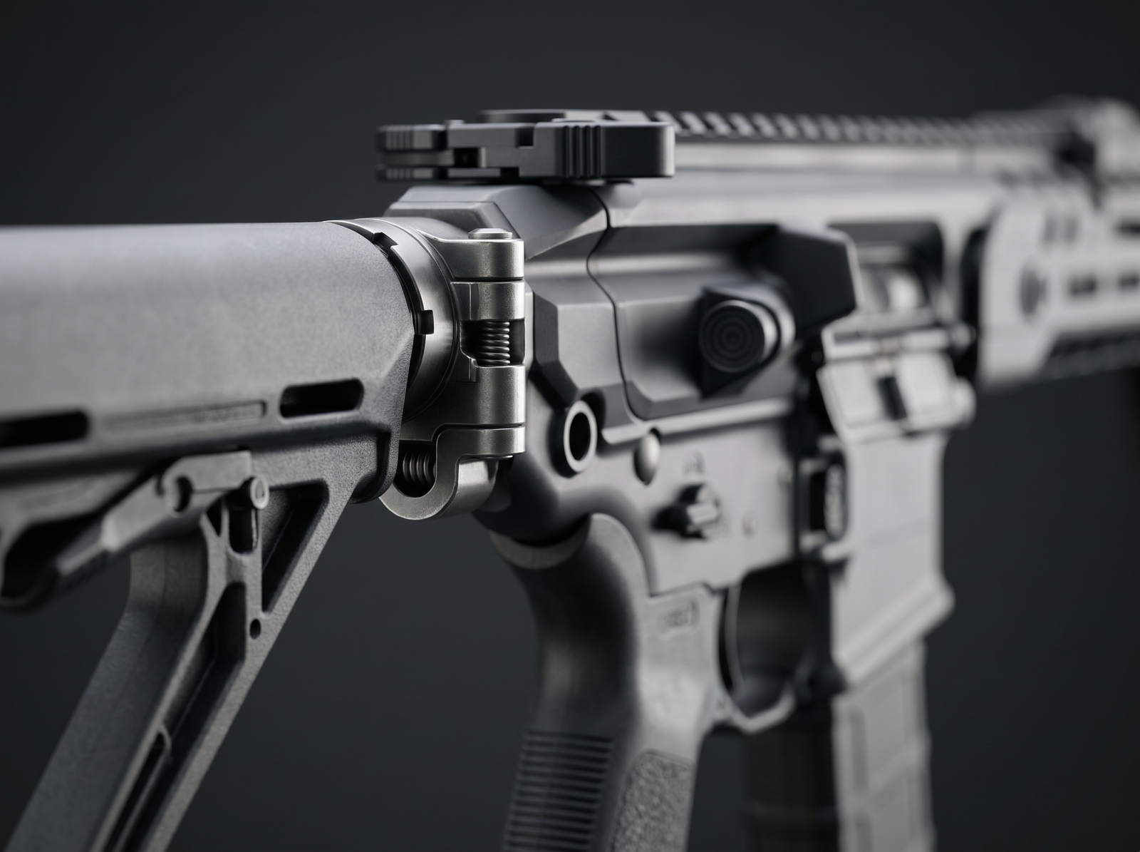 Sig MCX Spear LT Review (2026): 500 Round Test of the Next-Gen AR Alternative 4 Extreme macro close-up of Sig MCX Spear LT folding stock hinge mechanism showing the receiver-end buttstock pivot pivot, locking detent and no-buffer-tube receiver design with soft key light from camera left and rim light catching hinge edge on dark studio backdrop