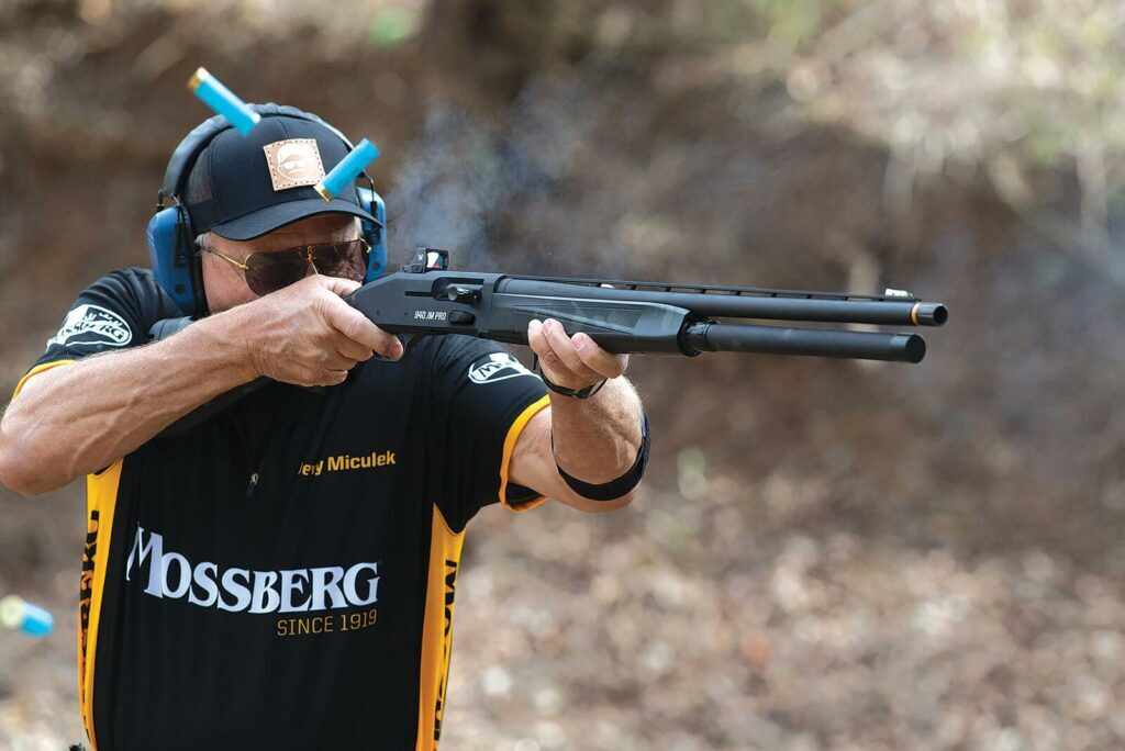 Jerry Miculek demonstrating the Mossberg 940 JM Pro competition shotgun at an outdoor 3-gun stage