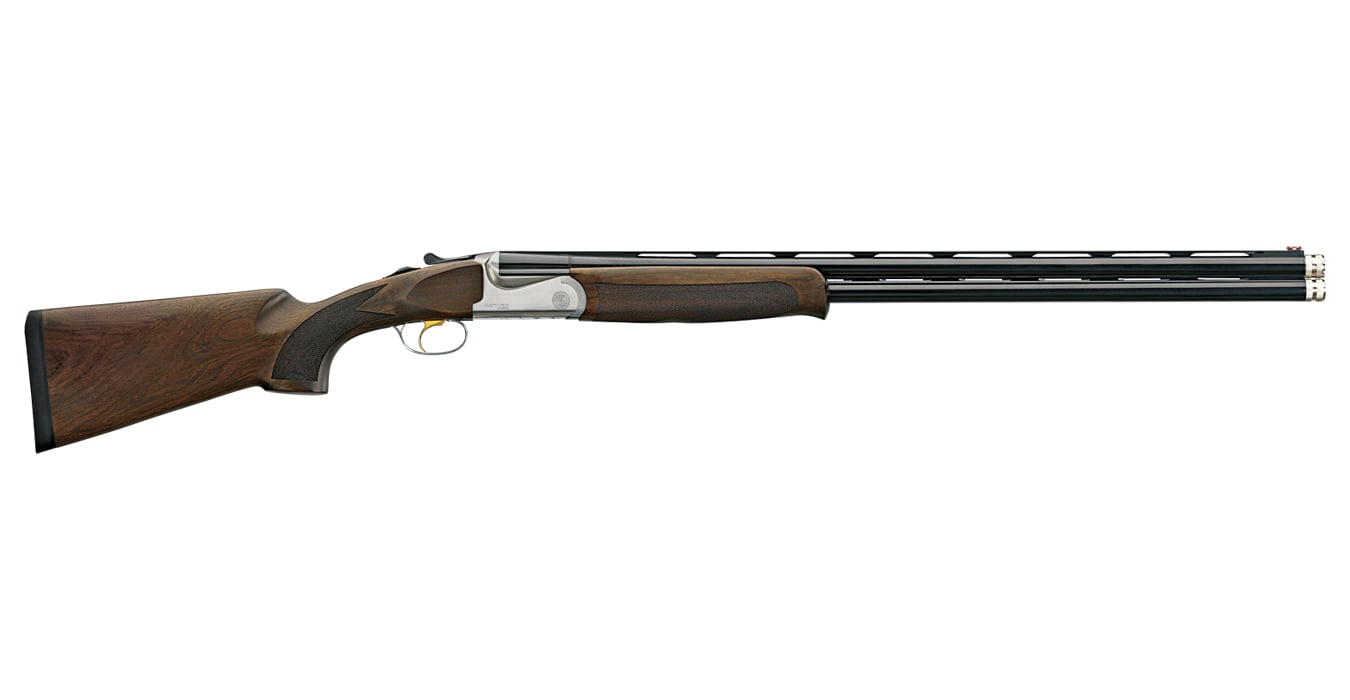 8 Best Over/Under Shotguns Under $1,000 in 2026 17 Franchi Instinct L over and under shotgun with polished silver receiver and walnut stock on a weathered red picnic table at a sporting-clays course with a printed shooter scorecard and pencil in cool morning blue-grey light