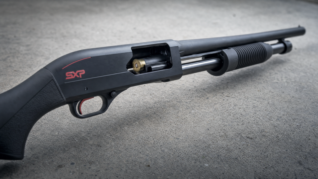 Winchester SXP Defender Review (2026): 500 Round Test of the Fastest Pump Shotgun 11 Winchester SXP Defender with action open, showing twin action bars and chamber