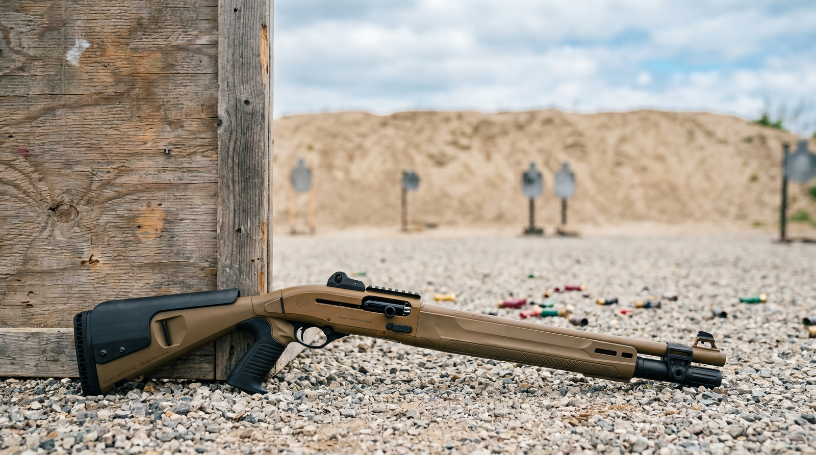 8 Best Tactical Shotguns in 2026: Semi-Autos and Pumps for Defense 34 Beretta 1301 Tactical burnt bronze FDE semi-auto shotgun leaning against wooden barricade at outdoor 3-gun competition stage with sand berm and steel target silhouettes