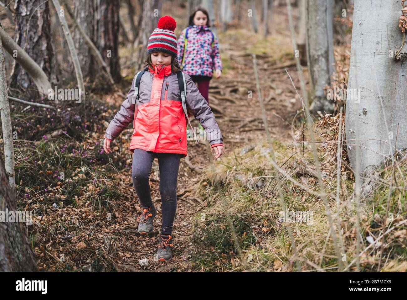 Youth Hunting (2026): The Honest Guide to Starting Kids Right 1 Father and young son walking through autumn hardwood forest wearing blaze orange, youth hunting introduction scene
