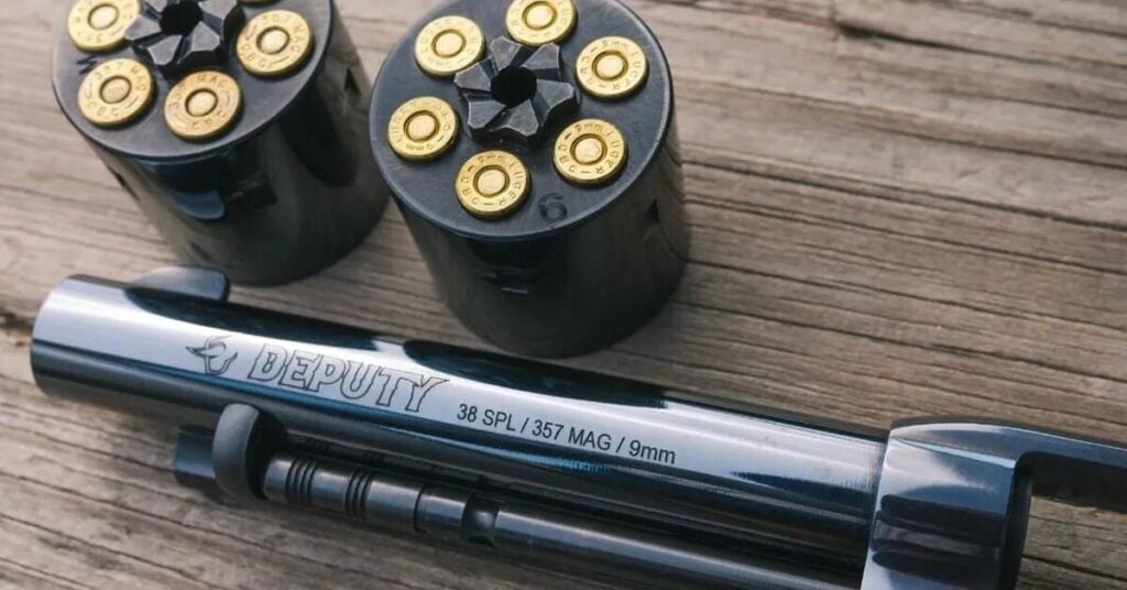 Taurus Deputy Dual Cylinder: One Single-Action, Three Calibers (2026) 2 Single-action revolver cartridges in .357 Magnum, .38 Special and 9mm laid out on weathered wood, illustrating the Taurus Deputy Dual Cylinder launch
