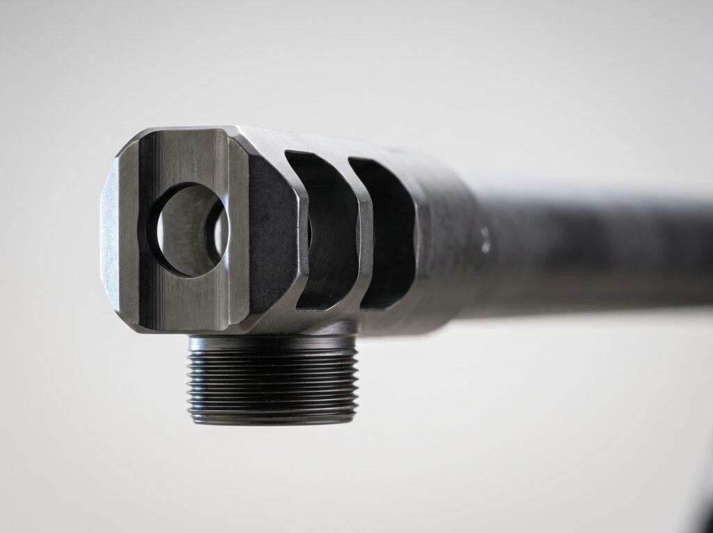 Bushmaster BA50 Review (2026): The Magazine-Fed .50 BMG Bolt Gun 3 Macro detail of the Bushmaster BA50 three-port muzzle brake