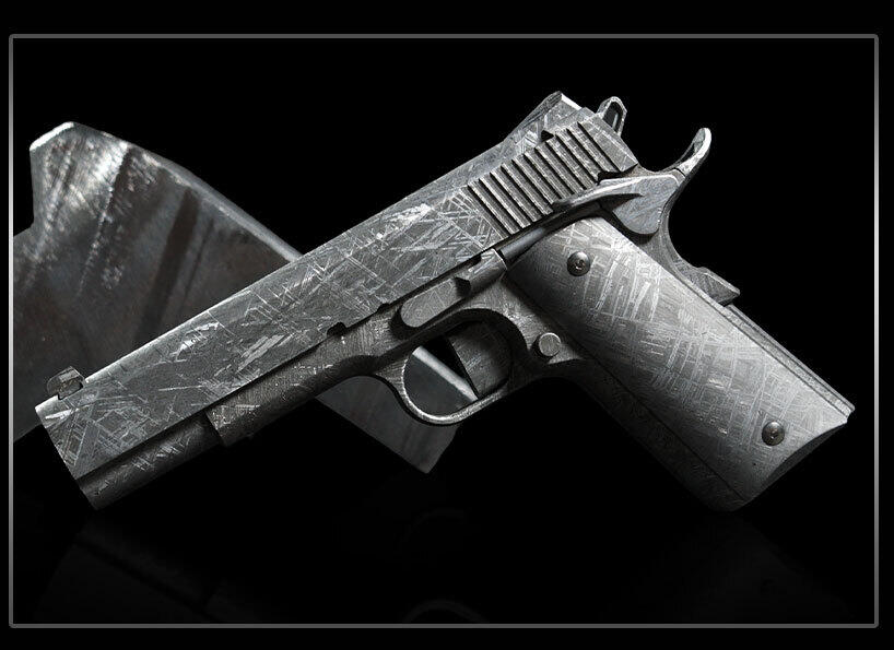 Bligh Guns Forges a 1911 From 4-Billion-Year-Old Meteorite Iron 3 Left-side profile of the Bligh Guns Meteorite 1911 resting on a cut slab of Muonionalusta meteorite