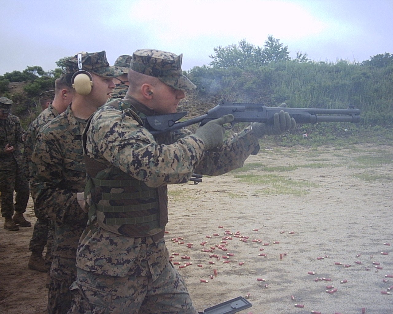 The Real Cost of a Movie Hero's Arsenal (What Iconic Movie Guns Cost) 3 U.S. Marines firing Benelli M4 semi-automatic combat shotguns on a range