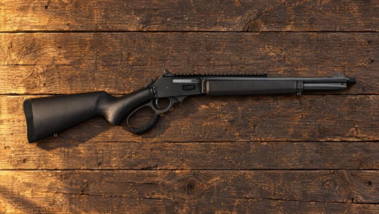 Rossi R95 Triple Black .444 Marlin lever-action rifle lying flat on weathered barn wood