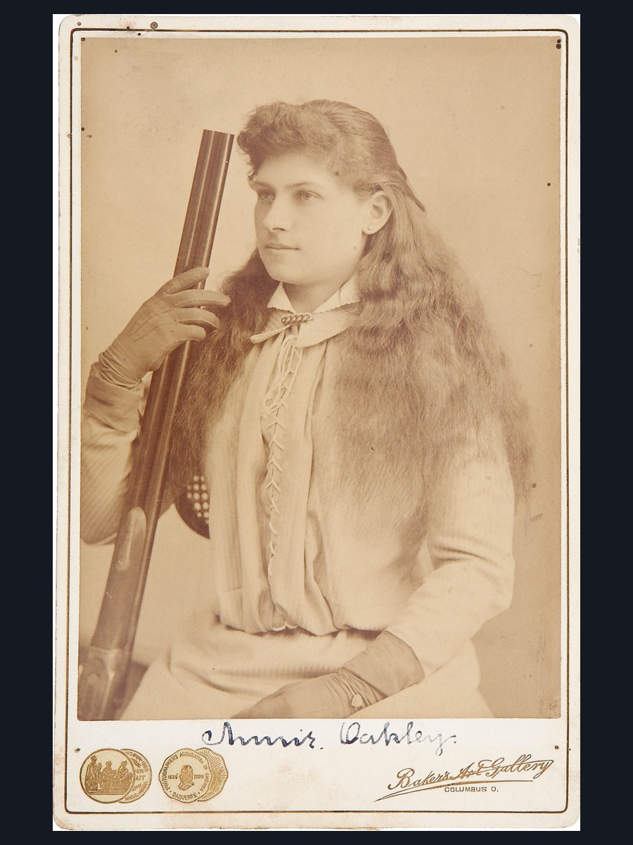 10 Legendary Women of the Gun (Historyx27s Greatest Markswomen) 2 Annie Oakley holding a rifle in an 1880s studio portrait