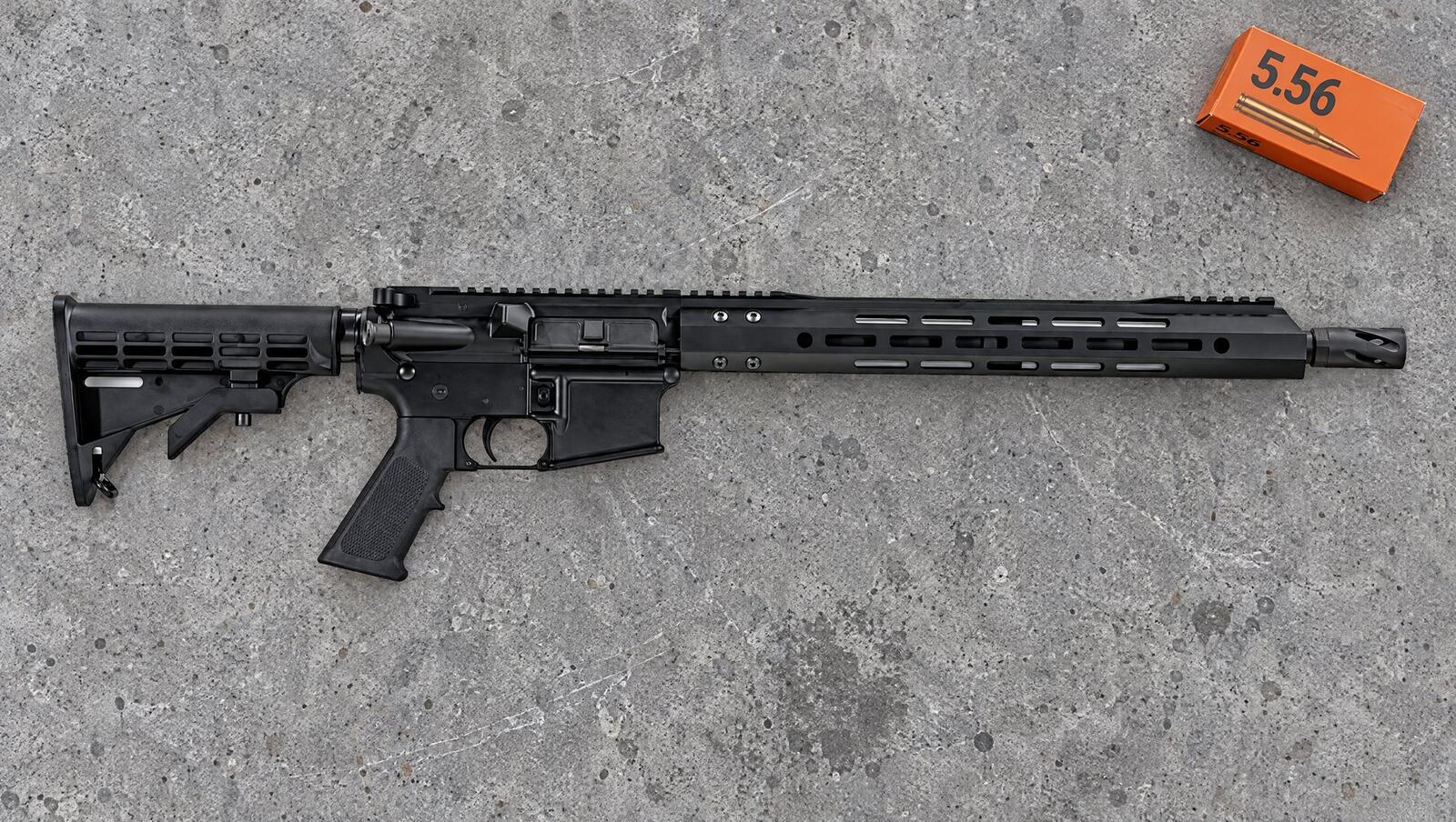Bear Creek Arsenal BC-15 AR-15 rifle on a gray concrete shooting bench with a box of 5.56 ammo
