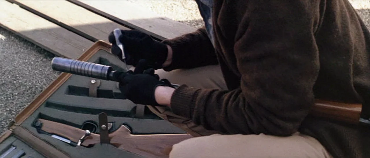 Scorpio fitting a Maxim style suppressor to his sporterized Arisaka takedown rifle in Dirty Harry