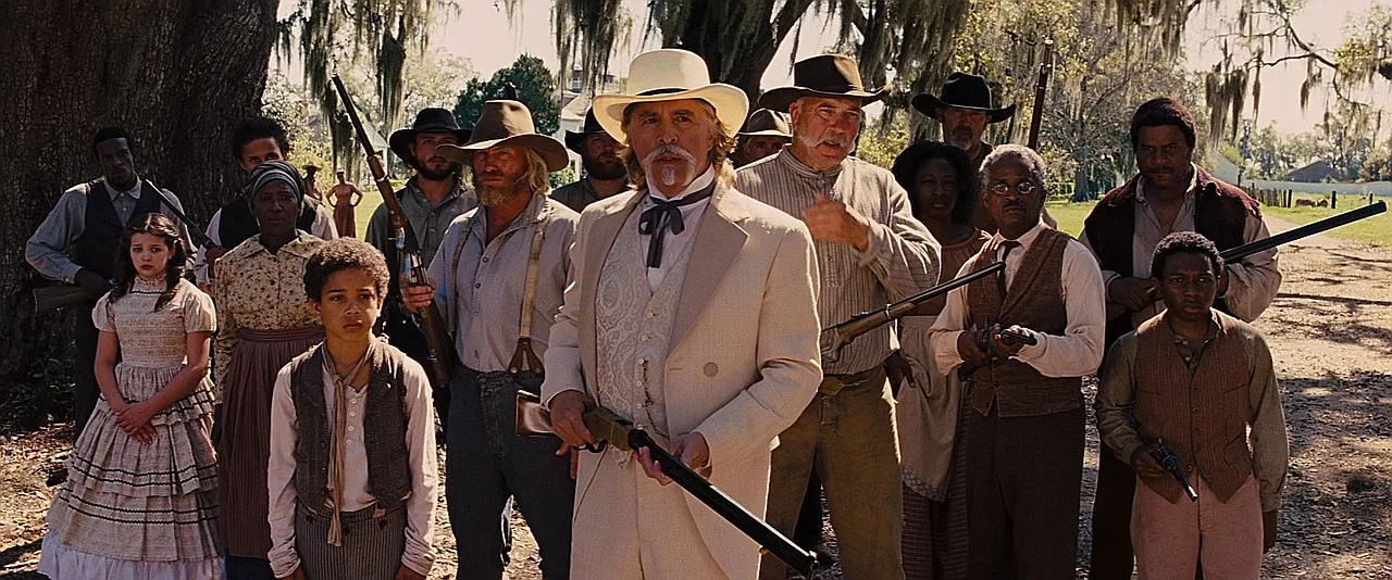 Big Daddy Bennett holding a Henry lever-action rifle with his armed men behind him in Django Unchained