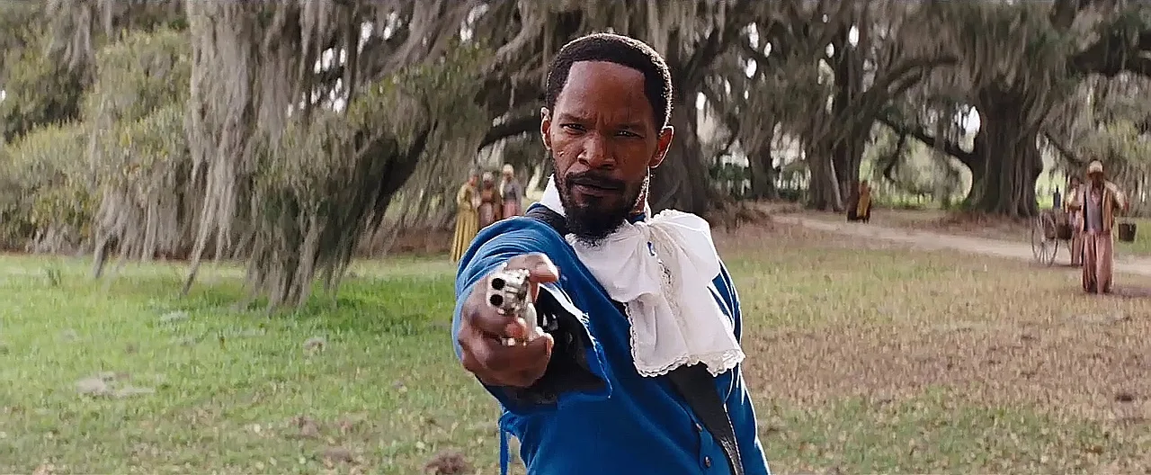 Django aiming the pearl-gripped double-barrel derringer in the blue valet suit in Django Unchained