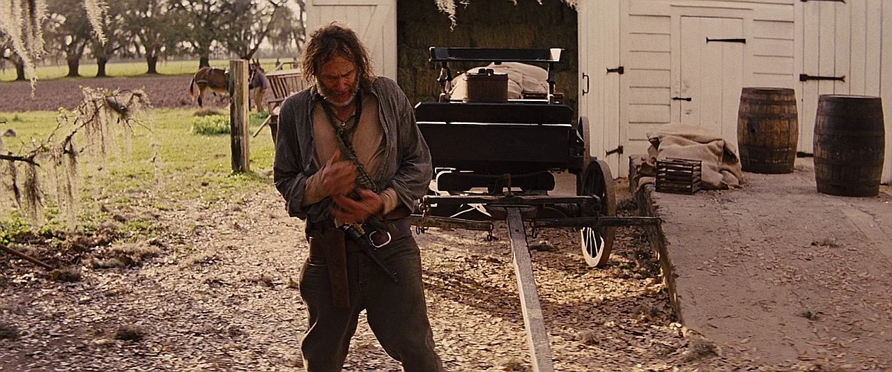 Lil Raj Brittle fumbling with a brass-framed Colt 1860 Army revolver in Django Unchained