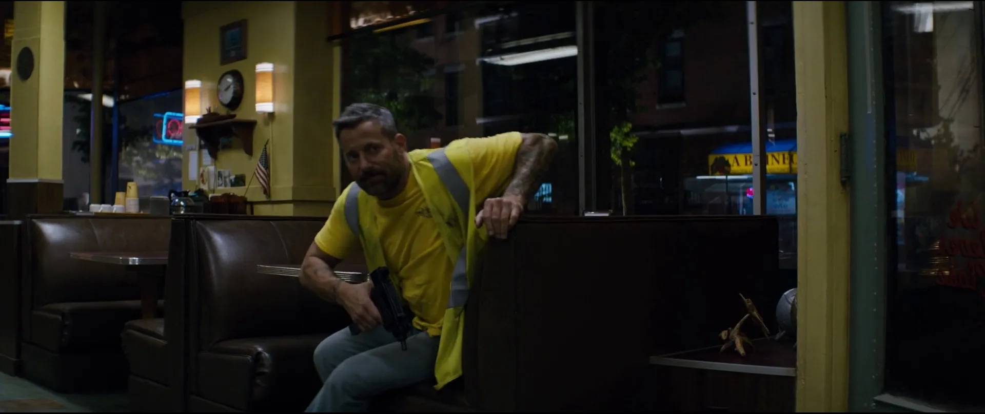A gunman disguised as a utility worker pulling a Micro Uzi in the diner booth in The Equalizer