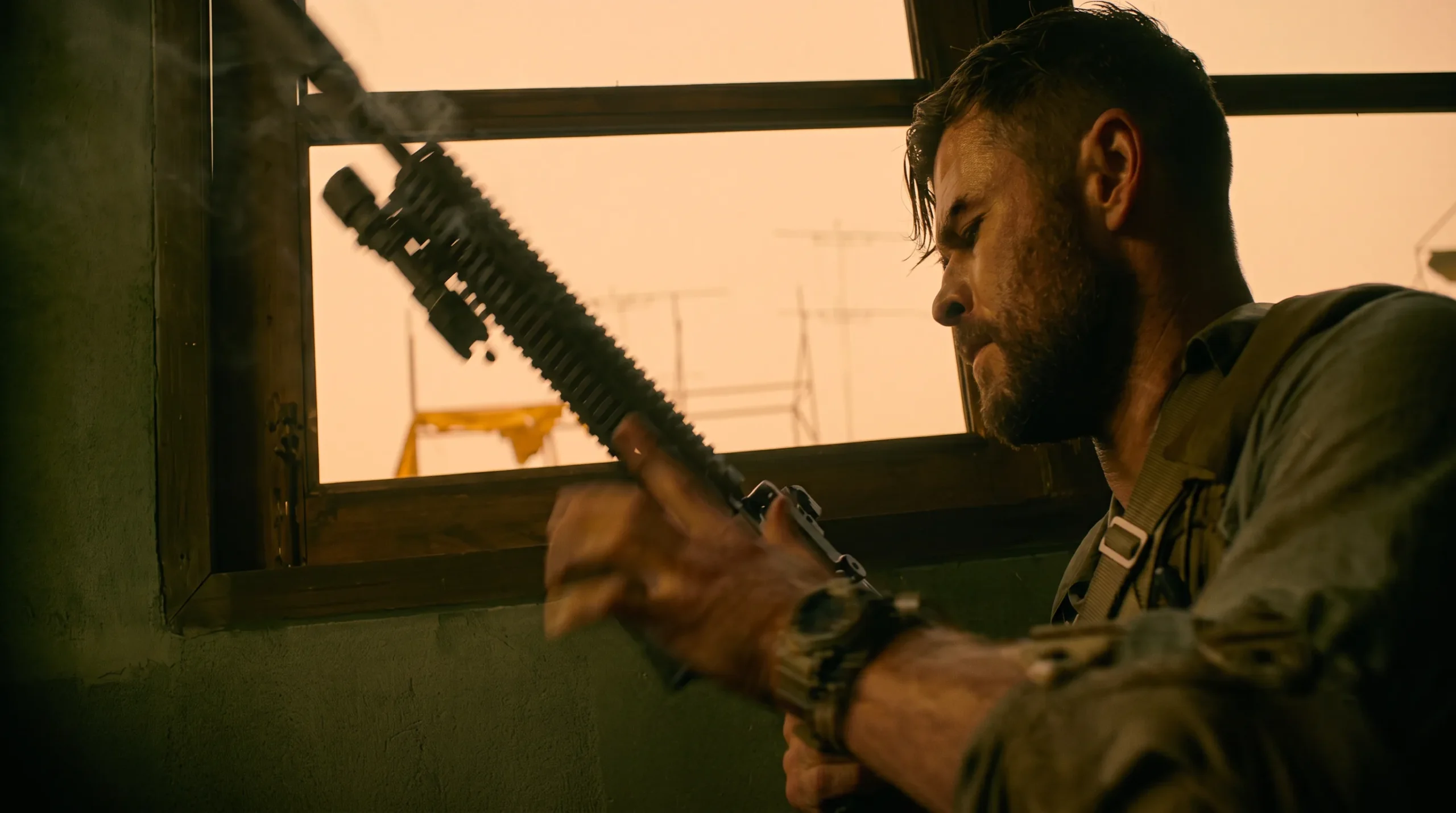 Tyler Rake working his suppressed carbine at a vehicle window in Extraction