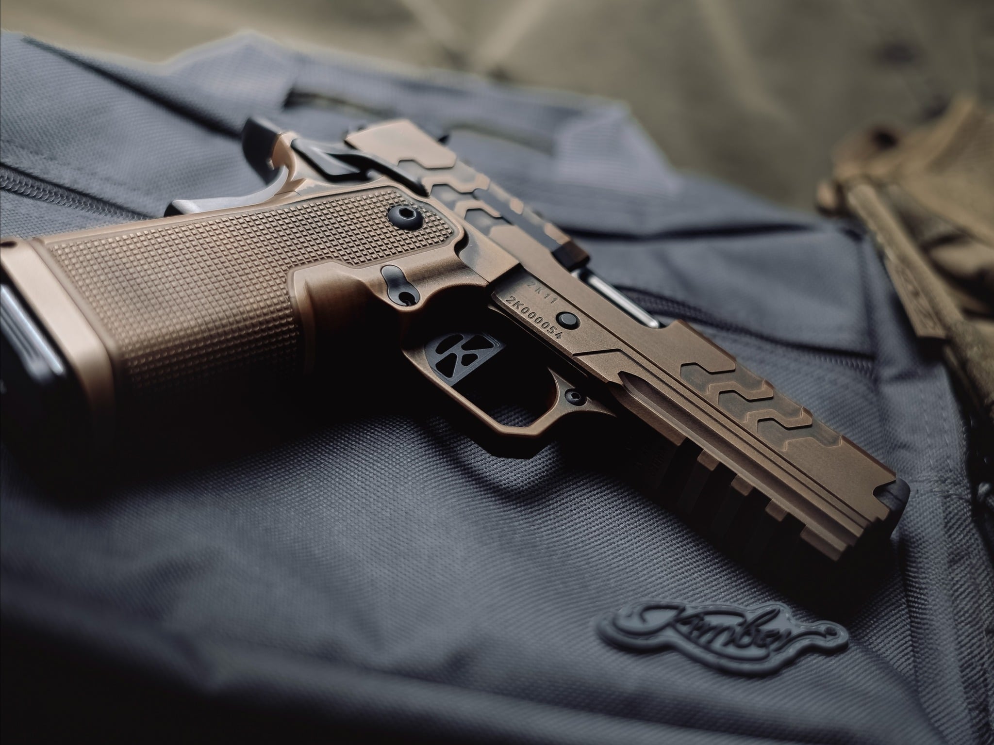 Kimber 2K11 double stack 1911 in bronze PVD on a Kimber range bag