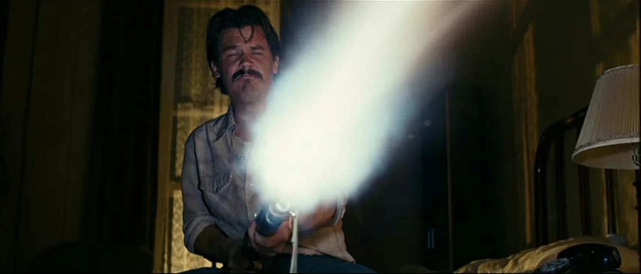 Llewelyn Moss firing his sawed-off Winchester Model 1897 one-handed in the motel in No Country for Old Men
