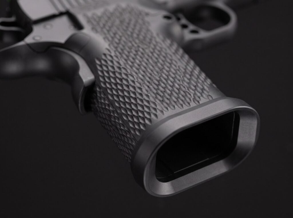 Macro detail of the Stealth Arms Platypus one-piece machined grip and bevelled magwell