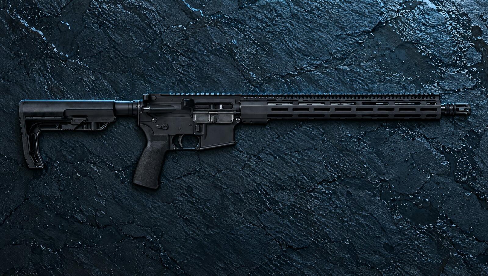 Radical Firearms RF-15 SOCOM AR-15 with a long M-LOK rail and minimalist stock on dark slate in blue dusk light