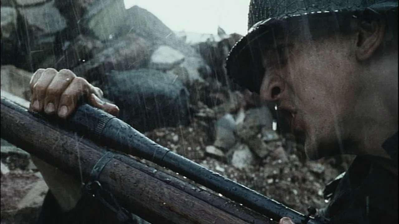 Private Jackson adjusting the long Unertl target scope on his M1903A4 Springfield in the rain in Saving Private Ryan