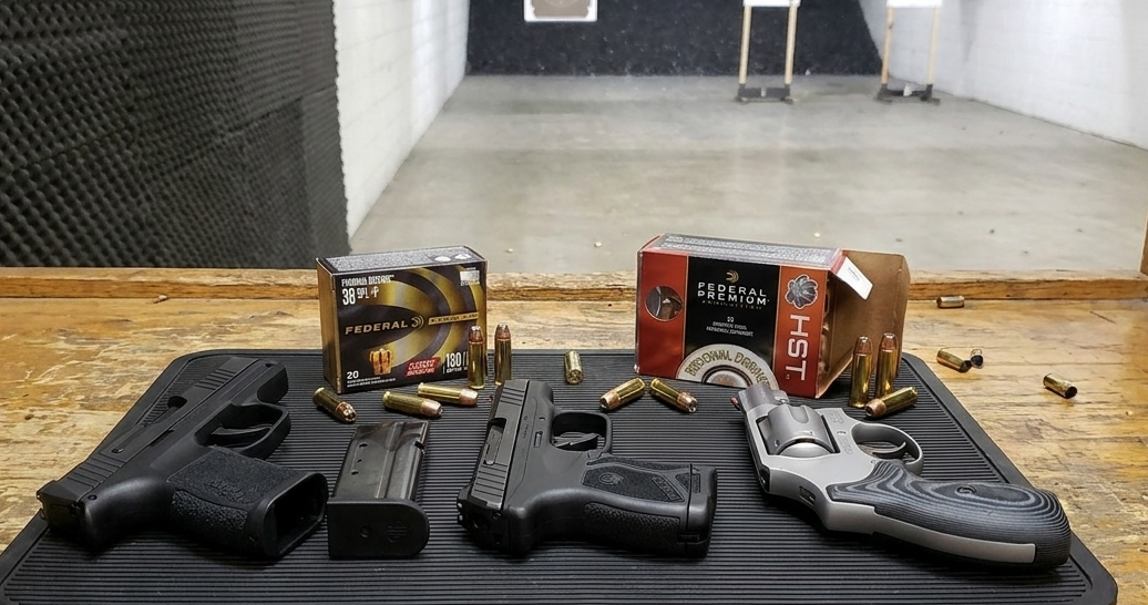 Federal 38 Special +P and 9mm HST ammunition with a revolver and two semi-autos on a range bench