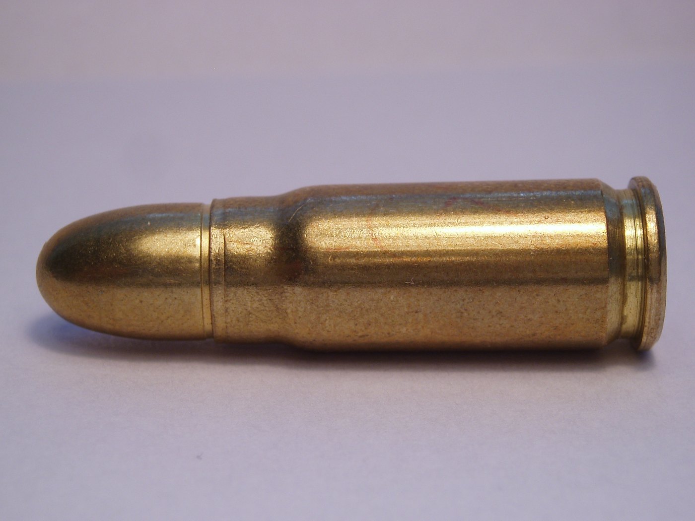 A single 7.62x25mm Tokarev cartridge with a full metal jacket bullet and bottlenecked brass case