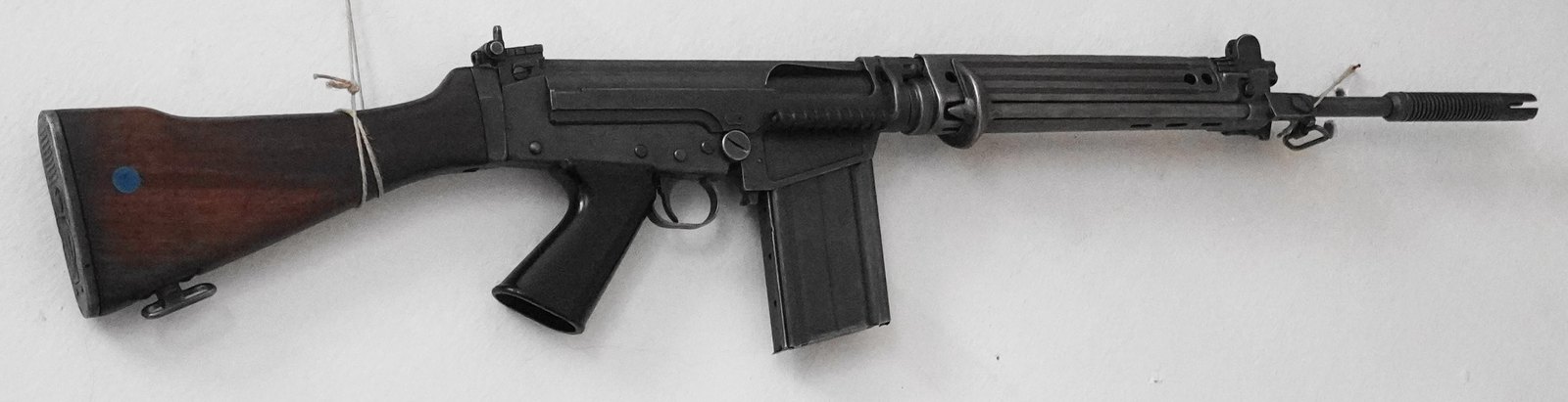 Left side of an Austrian StG 58 rifle with a wood buttstock and ribbed metal handguard