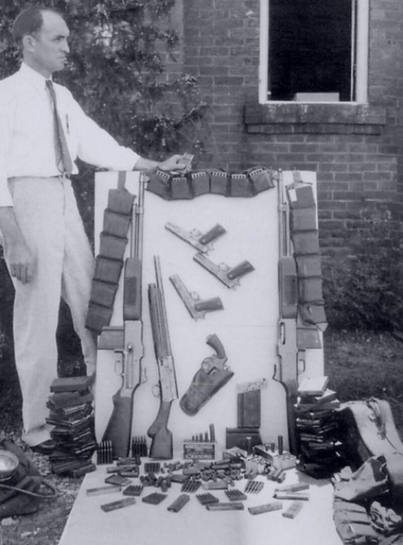 Browning Automatic Rifles, magazines, pistols and ammunition laid out after the 1934 ambush of Bonnie and Clyde