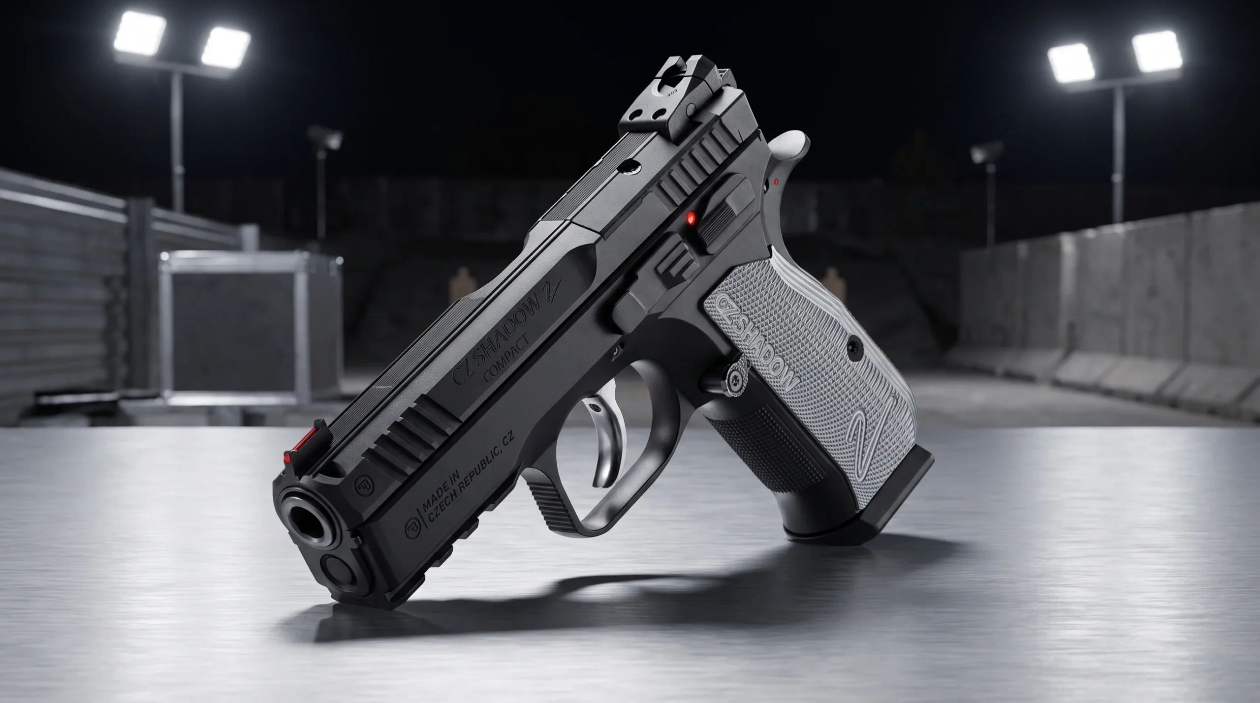 CZ Shadow 2 Compact pistol on a brushed aluminum competition range table under bright neutral white floodlights at night