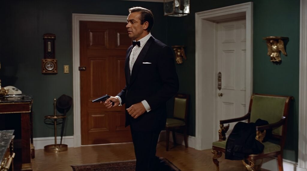 James Bond in a dinner jacket holding the long-slide Walther PP used in Dr. No