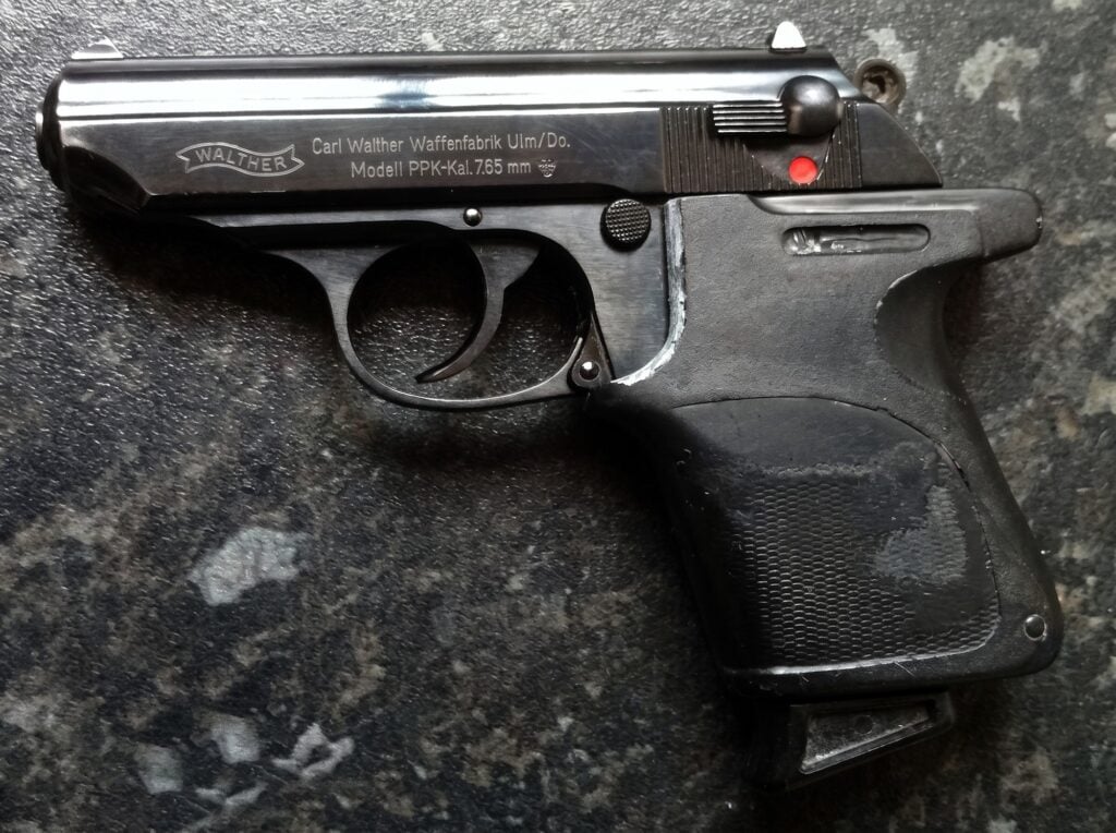 The Skyfall prop Walther PPK showing the Carl Walther 7.65mm slide rollmark under its custom grip