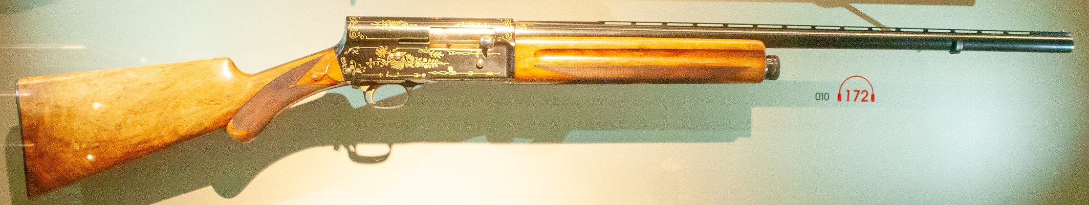 Browning Auto-5 shotgun with gold inlaid engraved receiver on display at the Grand Curtius museum in Liege