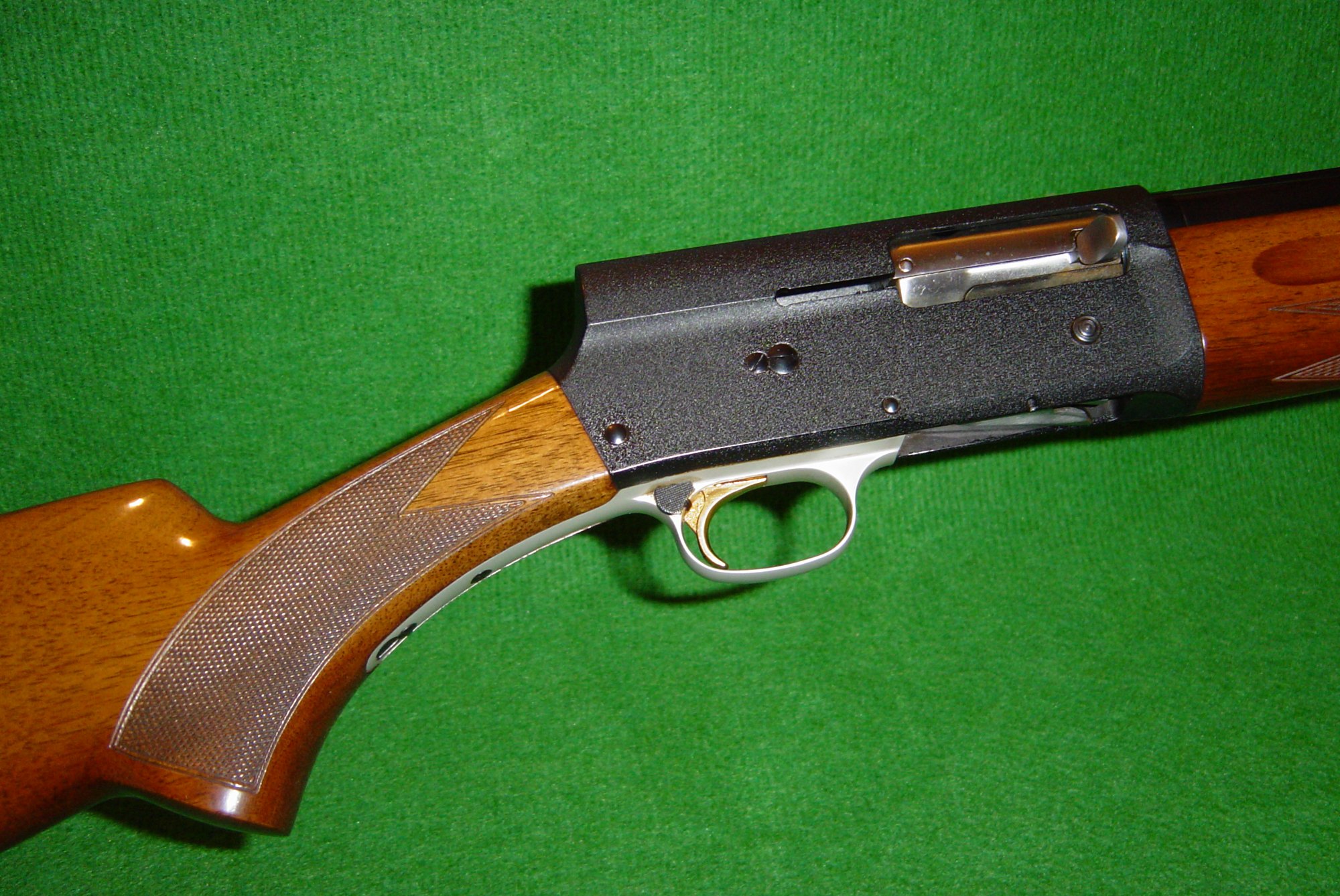 Close-up of a Browning Auto-5 receiver showing the squared humpback profile, bolt handle and checkered grip