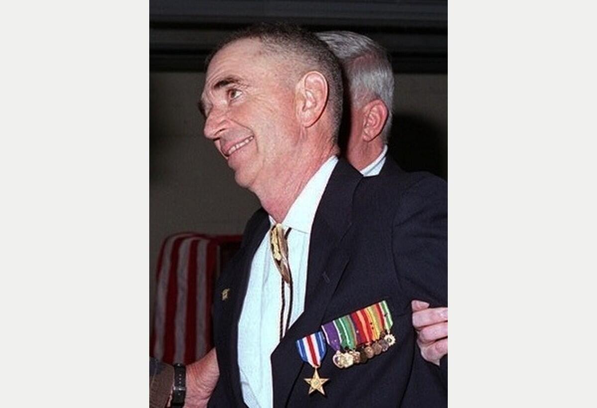 Carlos Hathcock smiling as he receives the Silver Star at Quantico in November 1996