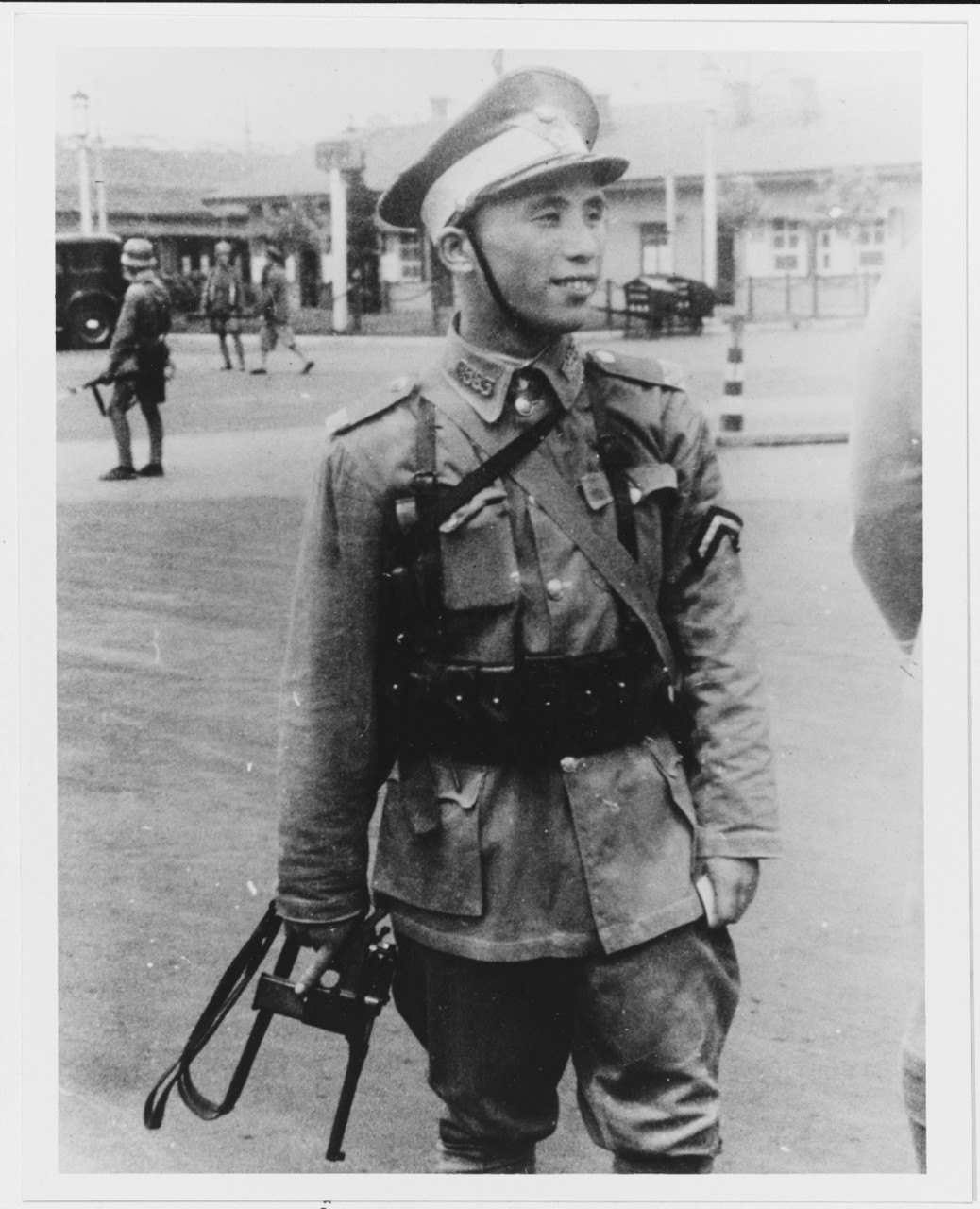 Chinese soldier in Shanghai in 1937 carrying a Mauser C96 type pistol by its sling