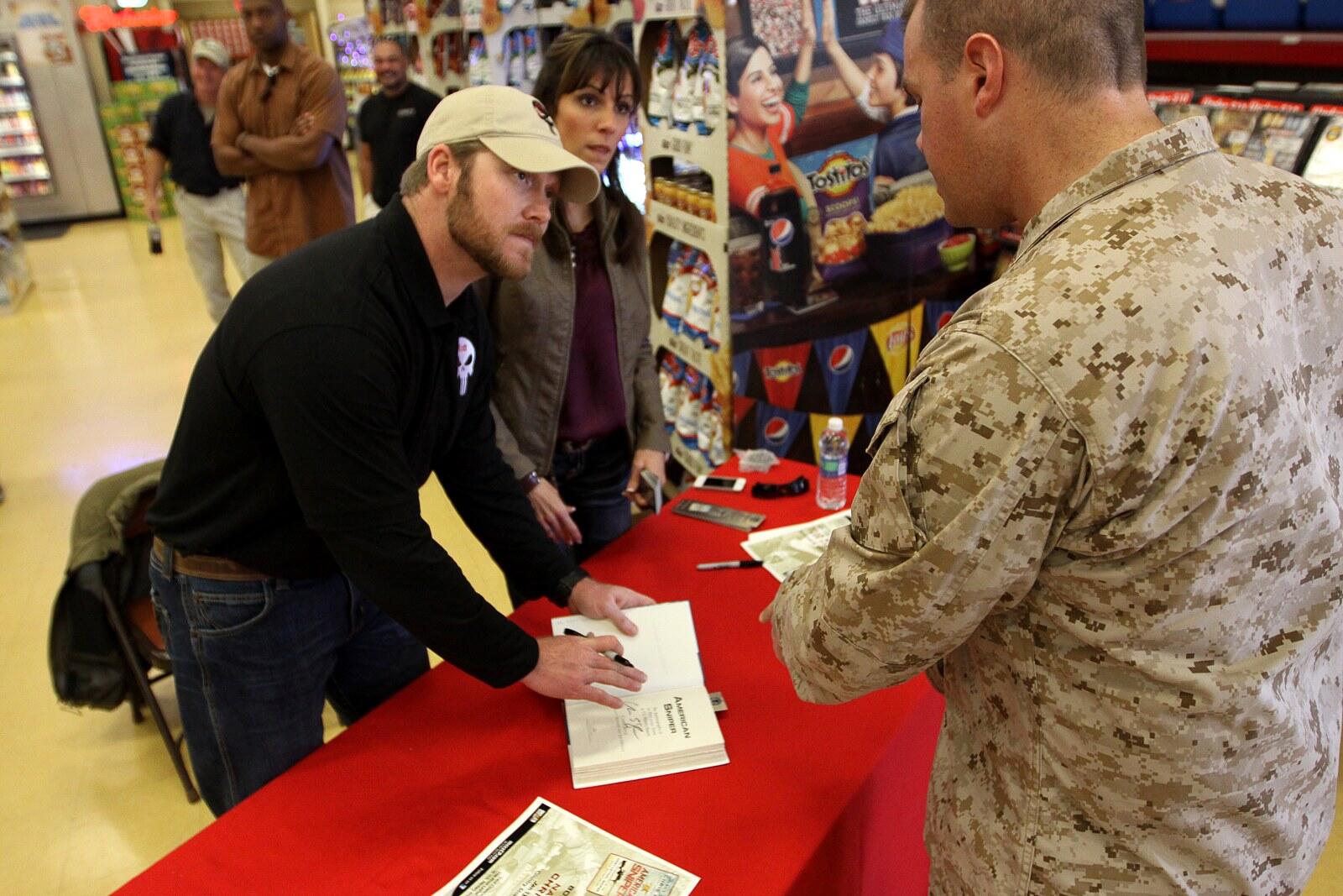 Chris Kyle and his wife Taya signing copies of American Sniper for a Marine at Camp Pendleton in January 2012