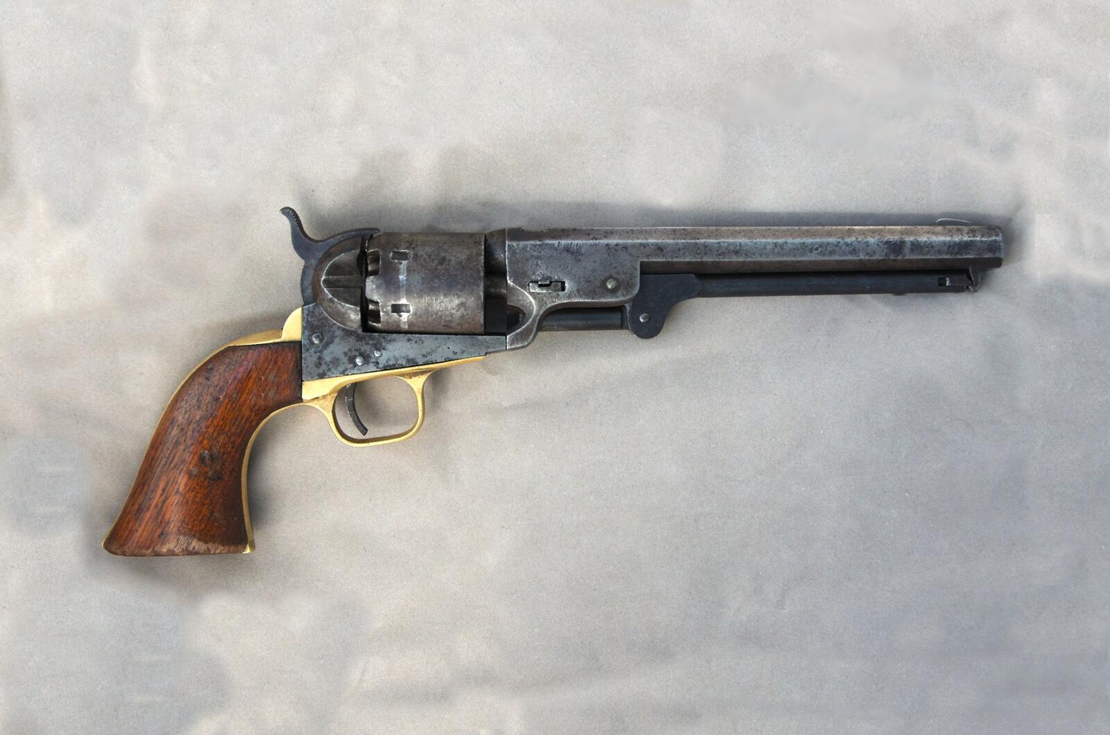 Colt Model 1851 Navy .36 caliber cap-and-ball revolver with a walnut grip and brass trigger guard