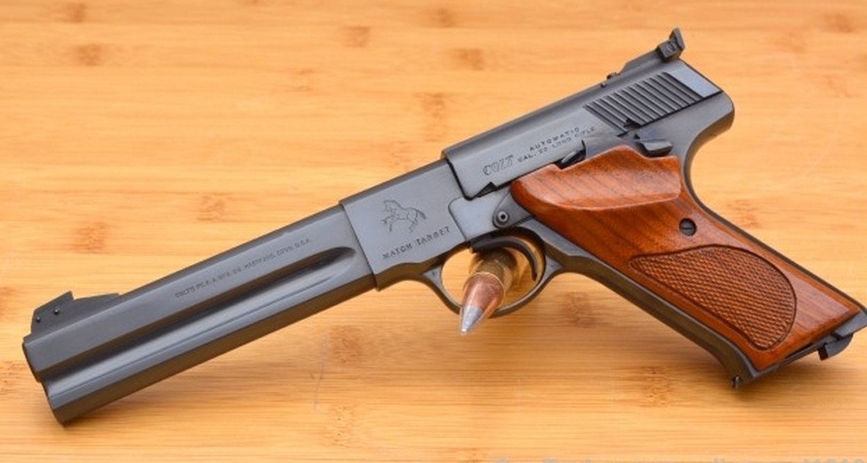 Colt Woodsman Match Target pistol with heavy slab-sided barrel, adjustable rear sight and walnut thumbrest grips