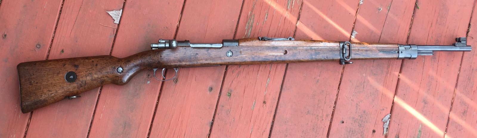 Czechoslovak vz. 24 Mauser short rifle, a Romanian-contract rifle likely made in 1942, lying on a painted wooden deck