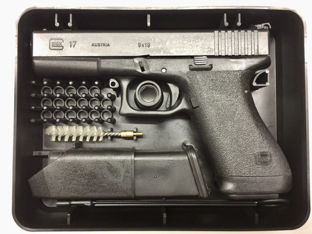 First generation Glock 17 pistol in its original plastic factory box with magazine and cleaning rod